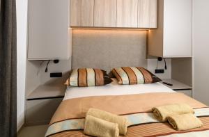una camera da letto con un letto con due cuscini di Luxury and Cosy Little House Ivinj 2 a Tisno (Stretto) Altre 43 foto