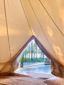 a tent with a view of a patio at LaplandLiv Glampingtent with private sauna at the lake! in Mellanström