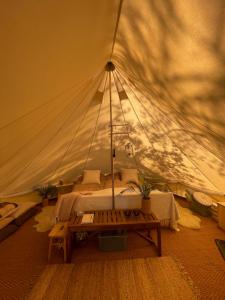 a room with a tent with a bed in it at LaplandLiv Glampingtent with private sauna at the lake! in Mellanström