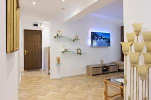 a living room with white walls and a wooden floor at 20 Apartment Centre in Bucharest