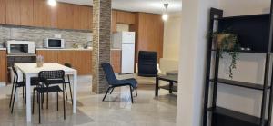 a kitchen and dining room with a table and chairs at RAY APARTMENT in Flogita