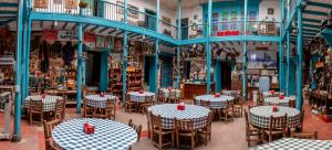 a restaurant with tables and chairs in a room at Hotel El Tesoro Sonson in Sonsón