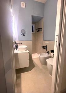 a bathroom with a toilet and a sink and a tub at Kyria Luxury Apartment in Vulcano
