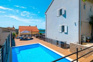 a swimming pool on the balcony of a house at POOL me up! in Šibenik