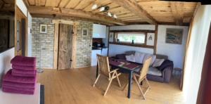 a living room with a table and chairs and a couch at Auci Guest house 1 in Liepāja