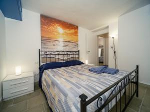 维耶斯泰LA FINESTRA SUL MARE - Antonella Apartment的卧室里有一张床，墙上挂着一幅画