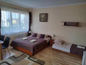Postel nebo postele na pokoji v ubytování Pokoje Goscinne Bartosz