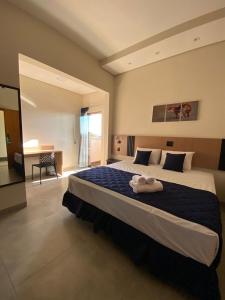 a large bedroom with a large bed with towels on it at Visionsul Hotel in Chapadão do Sul +72 photos