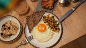 two plates of food with eggs and toast on a table at Villa Viva - ein Haus das Brunnen baut in Hamburg