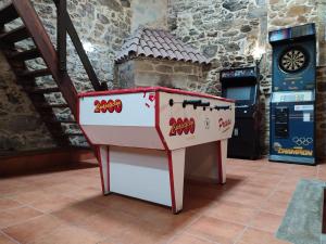 a red and white table in a room at Casa Floriña in Outes