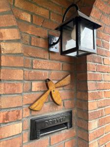 a street light with a ribbon on a brick wall at De Bijenkorf in Damme