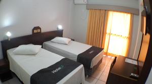 Postel nebo postele na pokoji v ubytování Hotel LF By Feliciano