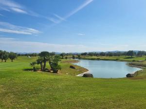 a view of a pond on a golf course at Urbanización Panorámica Golf in Sant Jordi