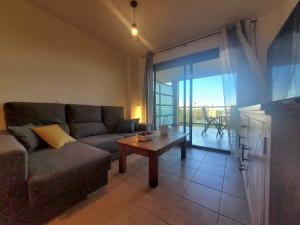 a living room with a couch and a table at Urbanización Panorámica Golf in Sant Jordi