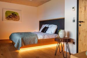 a bedroom with a bed and a table in a room at Hotel Frost in Maribor