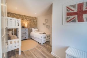 une chambre avec deux lits et un lit superposé dans l'établissement Jumble Cottage, à Seaview