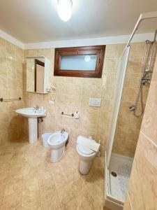a bathroom with a toilet and a sink and a shower at BeB all'Ombra del Castello in Trani +2 photos