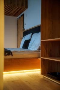 a bedroom with a bed with a wooden frame at Hotel Frost in Maribor