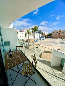 a balcony with a bench and a view of a street at Mulata Doré Suite in Corralejo
