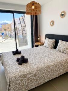 a bedroom with a bed with shoes on it at Mulata Doré Suite in Corralejo