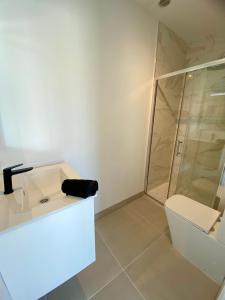 a bathroom with a shower and a sink and a toilet at Mulata Doré Suite in Corralejo +30 photos