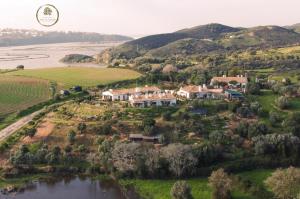 an aerial view of a house on a hill next to a river at Vale D Sancho Eco Turismo in Aljezur