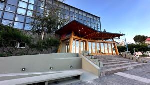 a building with a staircase in front of a building at Hotel Albatros in Ushuaia