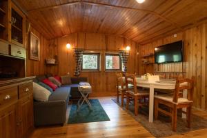 a living room with a couch and a table at Między Sosnami in Jedwabno