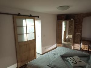 a bedroom with a bed and a wooden door at Ferienwohnung Urlaubsbasis Renate in Zittau