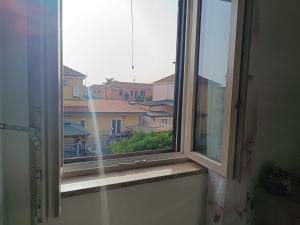 a window with a view of a city at La casetta di Nena in SantʼEufemia Lamezia