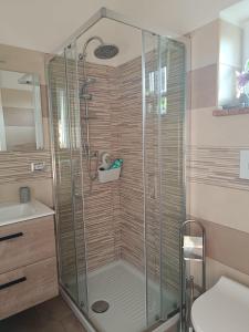 a shower with a glass door in a bathroom at La casetta di Nena in SantʼEufemia Lamezia