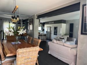 a living room with a couch and a table at Élégante maison circuit des 24h00 du mans in Le Mans