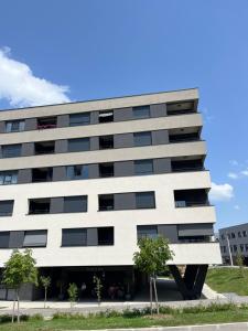a white building with trees in front of it at MM Apartments Zore in Zagreb