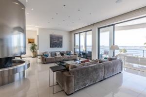 a living room with two couches and a television at Villa with Mediterranean Sea views in Mellieħa