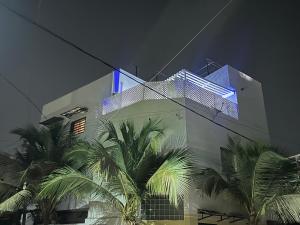 a building with a blue light on the side of it at Bouba in Dakar