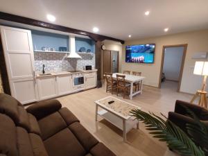 a large living room with a couch and a table at La casita de Mena in Hoz de Mena