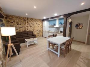 a living room with a couch and a table at La casita de Mena in Hoz de Mena +14 photos