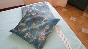 a blue tie with flowers on it sitting on a table at Villa Lilium in Bari