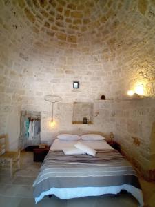 Postel nebo postele na pokoji v ubytování Trulli Chirulli