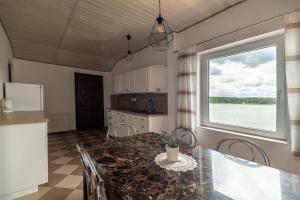 a kitchen with a table with chairs and a window at WDZYDZANIN in Wdzydze Tucholskie +23 photos