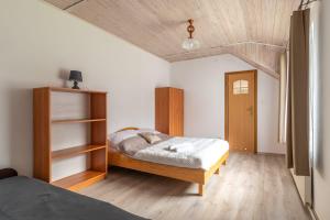a bedroom with a bed and a book shelf at WDZYDZANIN in Wdzydze Tucholskie