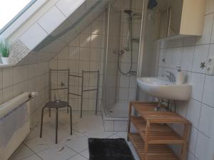 a bathroom with a sink and a shower at Ferienwohnung Grünberger Land in Grünberg +25 photos