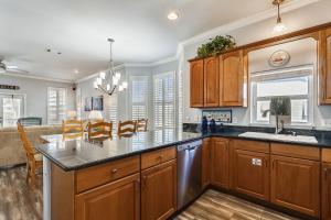 a kitchen with wooden cabinets and a kitchen island at Joes Dream- by Holiday Isle Properties in Destin +134 photos