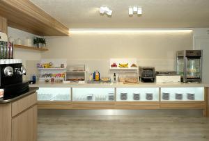 a kitchen with a counter with many appliances at Hotel Belcaire in Vall de Uixó