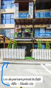 a building with a white fence in front of it at Stile CAPRI Studio cu terasă ALFA Saturn in Saturn