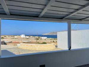 a large window in a room with a view of the ocean at Karras House in Kimolos +16 photos