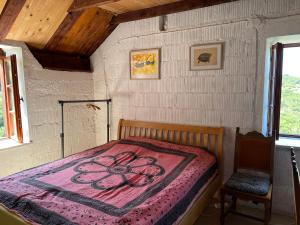 a bedroom with a bed with a flower blanket on it at Artist's House on the Mountain in Zelenika