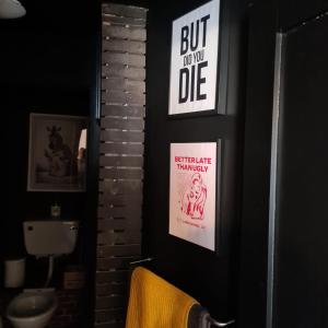 a bathroom with two posters on the wall at Zebra Lodge in Ród +14 photos