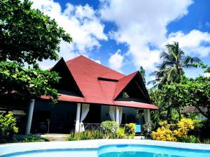 a house with a red roof next to a swimming pool at Nyumba Malaika in Malindi +29 photos