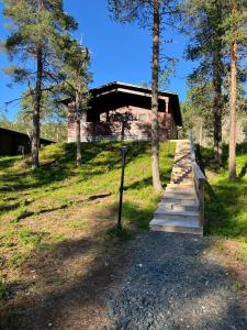 a wooden walkway leading to a house with trees at Villa Fox Ruka in Ruka
